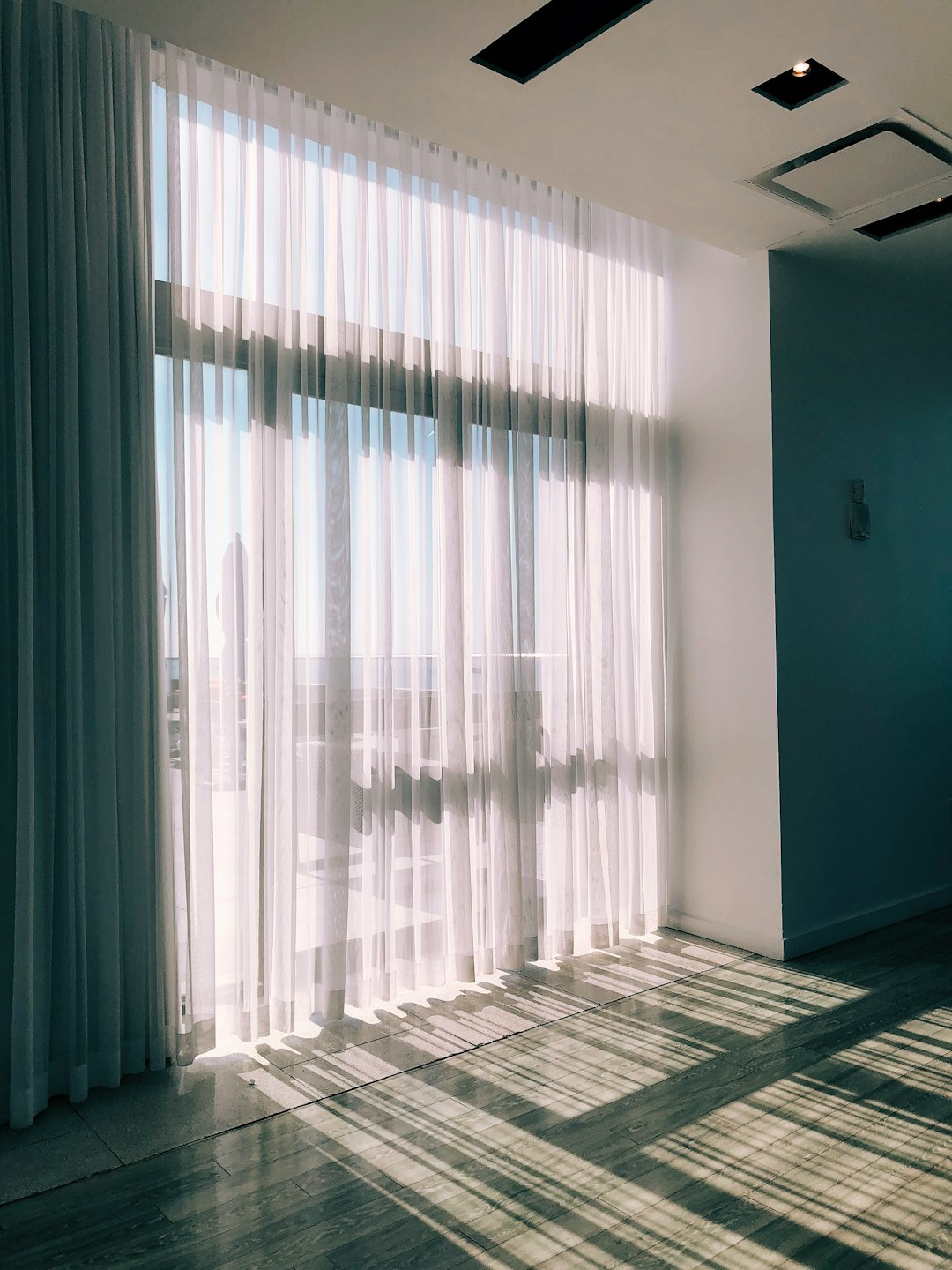 Picture of curtains in front of a light-filled window