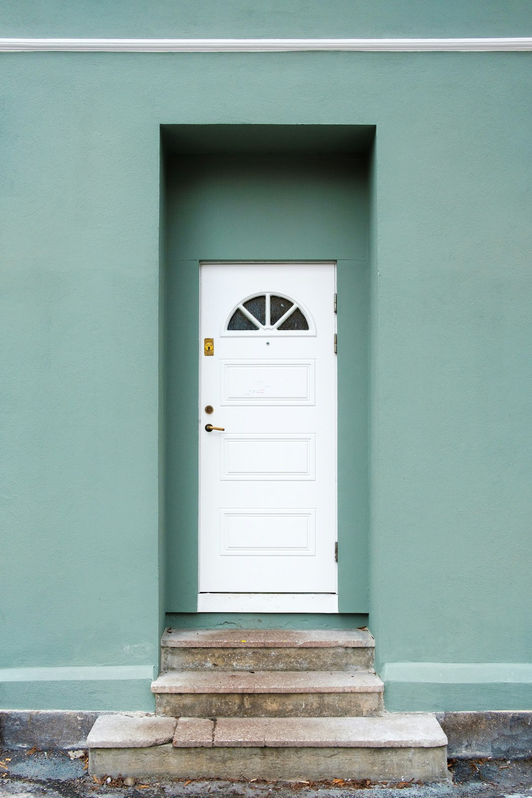 Picture of a front door with a semi-circular window at the top